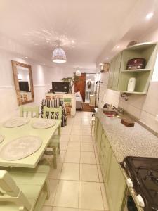 a kitchen with a table and chairs in a room at Casa Rio in Cruz del Eje
