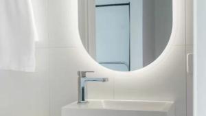 EpsomNouvelle Studio的浴室里有洗手池和镜子