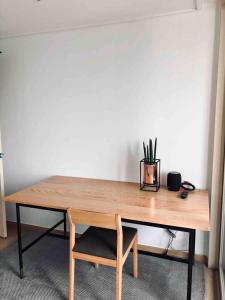 a wooden table with a plant on top of it at 여성전용1인숙소 Milli Home 