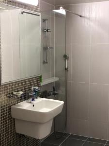 a bathroom with a sink and a shower with a mirror at 여성전용1인숙소 Milli Home 
