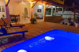 a swimming pool on a wooden deck with a house at Apartamentos da Casa Azul in Trancoso +9 photos