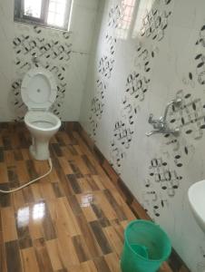 a bathroom with a toilet and a sink at 2 Bedroom Shreeji Kunj in mayapur +9 photos