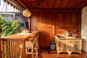 an outdoor kitchen with a table and a stove at Langkih Private Villas in Tegalalang