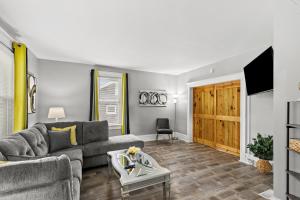 a living room with a couch and a table at Spacious Cottage near Airport, Hospitals, and Highways in Bel-Ridge
