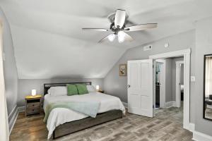 a bedroom with a bed and a ceiling fan at Spacious Cottage near Airport, Hospitals, and Highways in Bel-Ridge