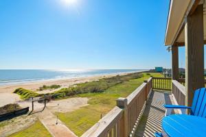 a view of the beach from the balcony of a house at Deja Blue home in Caplen