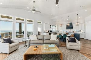 a living room with a couch and a table at Deja Blue home in Caplen +63 photos