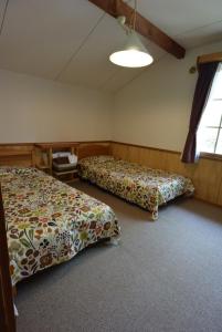 a bedroom with two beds in a room at Pension Noel in Kaminoyama