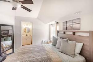 a bedroom with a large bed and a mirror at Sandy Pines Perch - Your Indian River Dock Life Base Camp in Sebastian