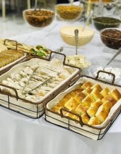 a table topped with trays of bread and pastries at Wadirum Leen camp in Wadi Rum