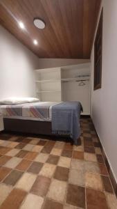 Postel nebo postele na pokoji v ubytování Chalé Gravatinha