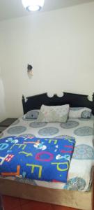a bed with a blue comforter and pillows on it at Pyramids Porto Sokhna Hotel Apartments in Ain Sokhna