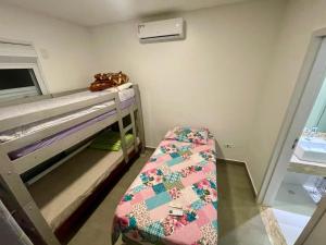 a small room with a bunk bed and a bunk bed at Mansão Maretti in Bertioga +47 photos