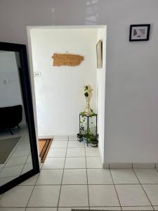 a hallway with a mirror and a room at Beach Hub 7 Mins to Airport in Carolina
