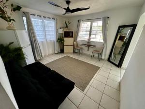 a living room with a couch and a table at Beach Hub 7 Mins to Airport in Carolina