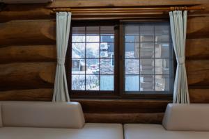 a living room with a couch and a window at Terrace Niseko Glide in Kutchan