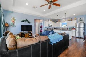 Il comprend un salon avec un grand canapé et une cuisine. dans l'établissement After Dune Delight Home, à Stingaree