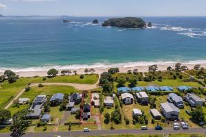 an aerial view of a caravan park next to the beach at Hosts on the Coast Hahei Sands Villa A in Hahei