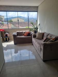 een woonkamer met twee banken en een groot raam bij vacation home Bonito PE in Bonito