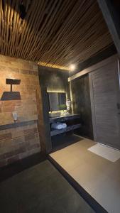 a room with a bathroom with a tub and a window at CARROLINE homestay ricefield in Kapal