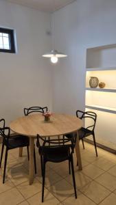 a dining room with a table and chairs and a light at Casa37 in Buenos Aires +2 photos