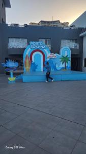a man is walking in front of a sign at Pyramids Porto Sokhna Hotel Apartments in Ain Sokhna