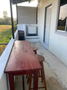 a wooden table in the back of a house at D'Bendang Homestay in Tumpat +15 photos