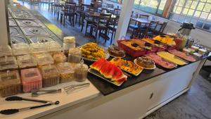 a buffet with many different types of food on it at Pousada Miniférico in Campos do Jordão