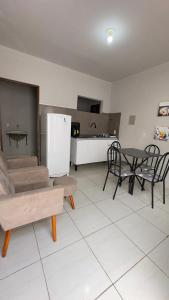 a living room with a couch and a table at Pousada Atalaia in Cuiabá
