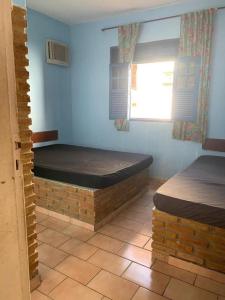 Postel nebo postele na pokoji v ubytování Condomínio Village do Itanhém