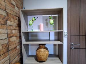 a shelf with a vase in a room at Turtle Nest in Hua Hin +14 photos