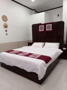 Ένα ή περισσότερα κρεβάτια σε δωμάτιο στο Le Charme Pakbeng Villa