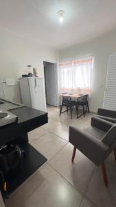 a living room with a piano and a table and chairs at Pousada Atalaia in Cuiabá +35 photos