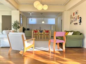 a living room with a couch and two chairs at The FLOW HOUSE in Suwon +26 photos