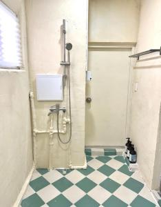 a shower in a bathroom with a checkered floor at The FLOW HOUSE in Suwon