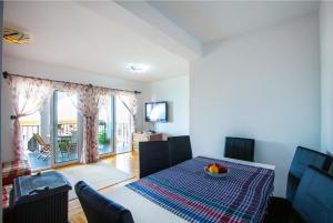 a dining room with a table with a bowl of fruit on it at Apartments Pines in Bar