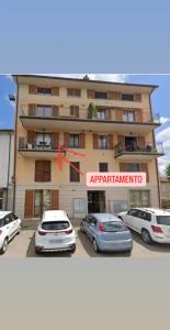 a building with cars parked in front of it at Monolocale di Kris in Borgo a Giovi