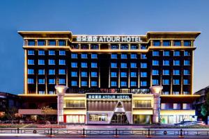 a hotel building with a sign that reads the avalon hotel at Atour Hotel Wuhan Chuhehanjie Xiu Theater in Wuhan