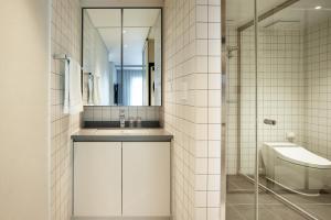 a bathroom with a sink and a mirror and a toilet at Yeouido Park Hotel in Seoul +16 photos