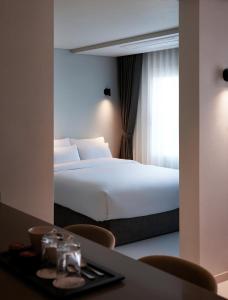 a hotel room with a bed and a table with chairs at Yeouido Park Hotel in Seoul