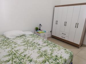 a bedroom with a bed and white cabinets at Beautiful and cozy home with Rent a car available in San Salvador
