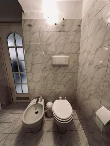 a bathroom with a toilet and a bidet and a sink at Parking available- Appartamento in centro storico a Genova in Genova