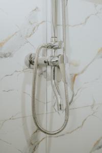 a shower with a hose attached to a wall at MY BOO PRIVATE by DRAGONFLY in Nusa Penida +50 photos