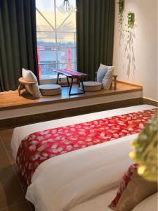 a bedroom with a bed with red hearts on it at Umi Resort 菩提有米 in Sihanoukville +78 photos