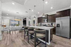 una cucina con una grande isola con sgabelli da bar di New 2025 Bambi Orlando Pool Vacation Home a Clermont