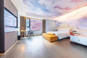 a hotel room with a bedroom with a painting on the ceiling at Atour Hotel Wuhan Chuhehanjie Xiu Theater in Wuhan +38 photos