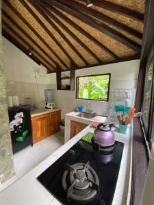 a kitchen with a stove top oven in a room at Ubud jungle House behind bintang supermarket ubud in Ubud