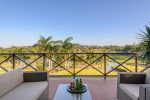 a patio with two couches and a table with drinks on it at Villa 2527 San Lameer in Southbroom