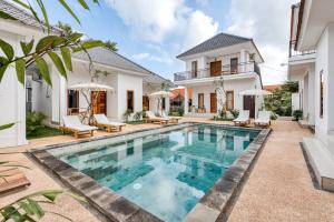 a swimming pool in the backyard of a house at Lala Panzi Villa by Manara in Jimbaran