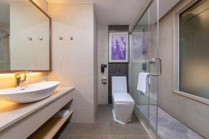 a bathroom with a sink and a toilet and a shower at Lavande Hotel Guangzhou Panyu Chimelong Xiajiao Metro Station Branch in Guangzhou +33 photos